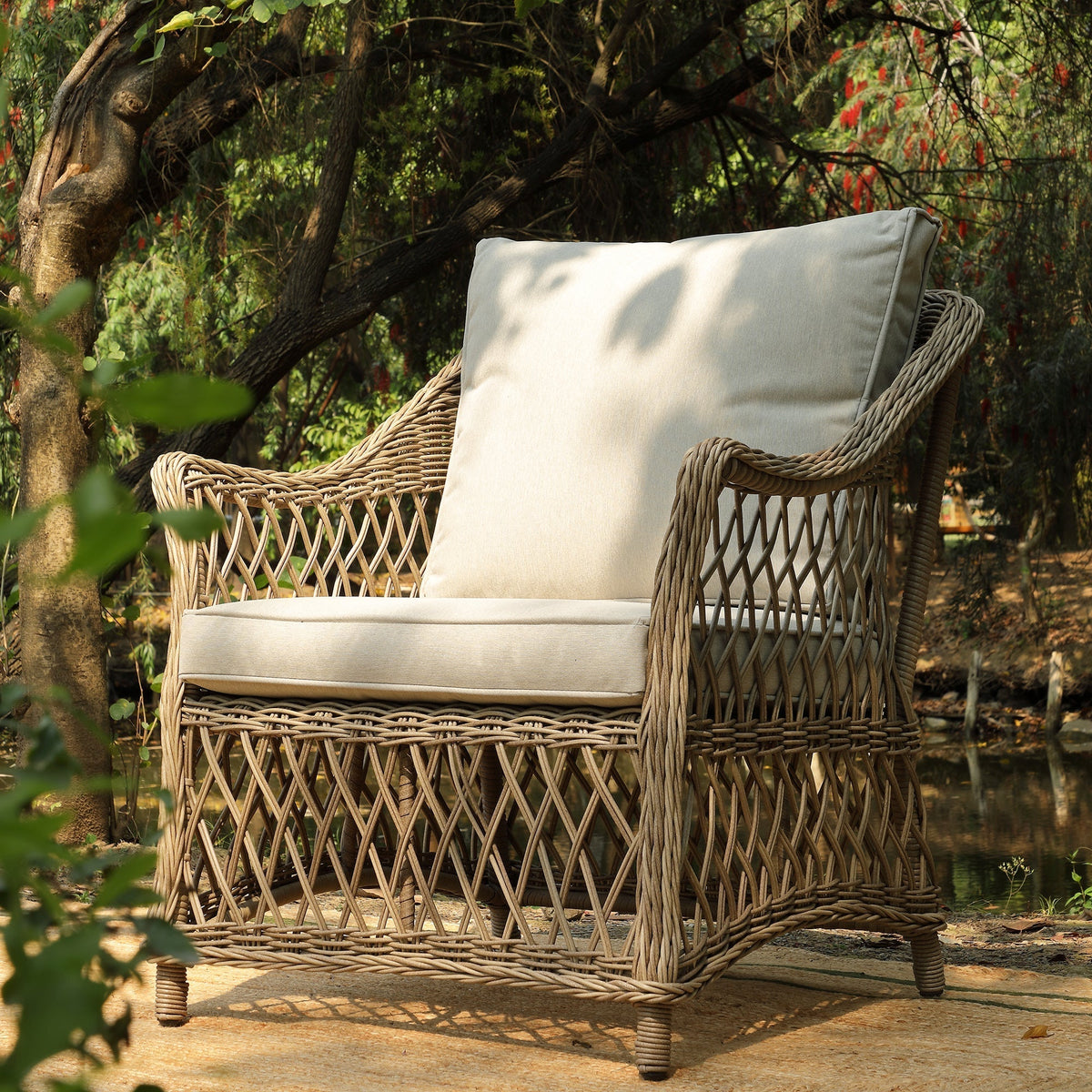 Willowbrook rattan armchair showing the lattice weave arm detail