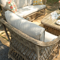 Willowbrook rattan armchair and sofa arranged around the rising table – image 12 of 15