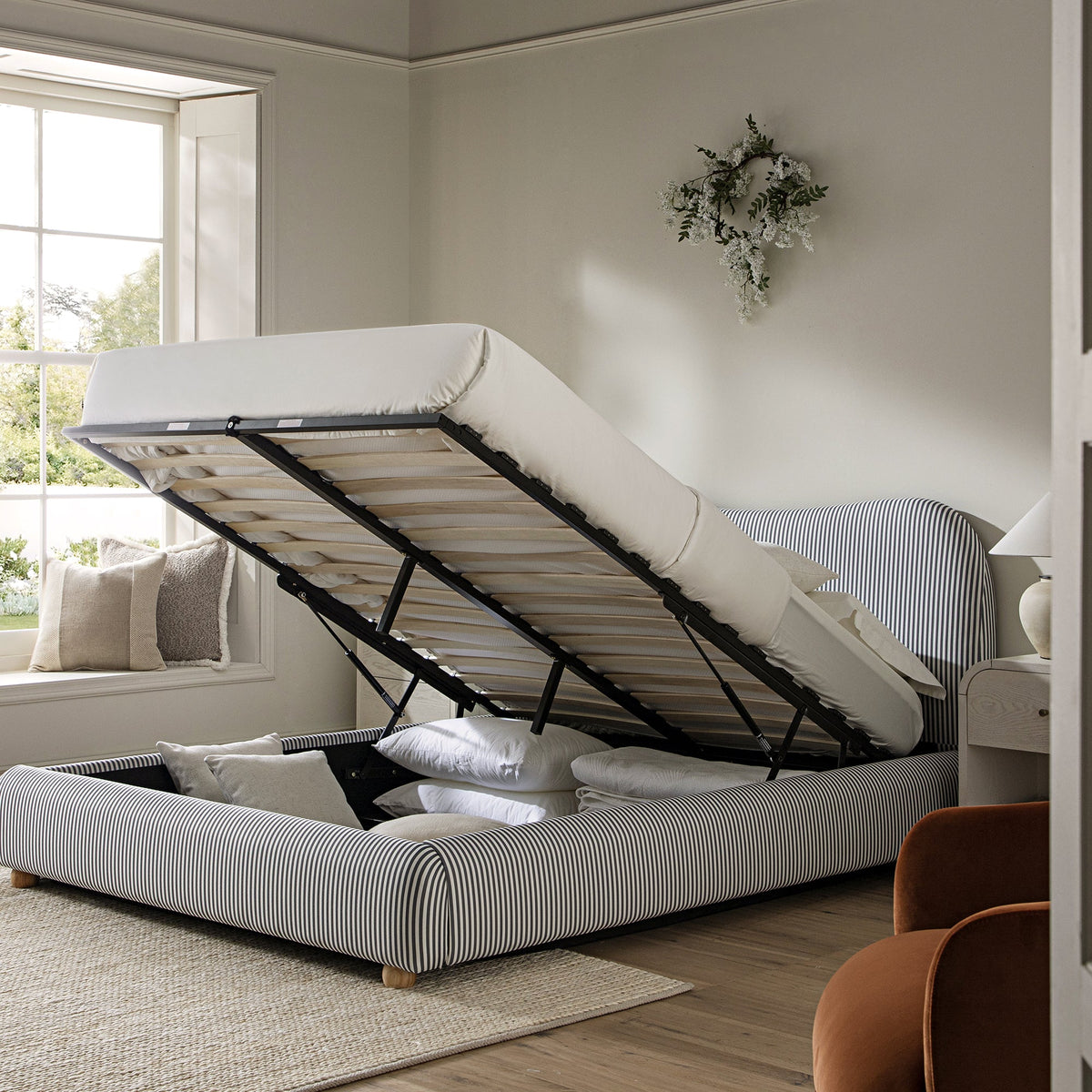 Egerie Curved Headboard Ottoman Storage Bed in Slate Blue Striped Fabric